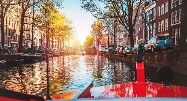 Cruising along Amstel Canal in Amsterdam, Netherlands