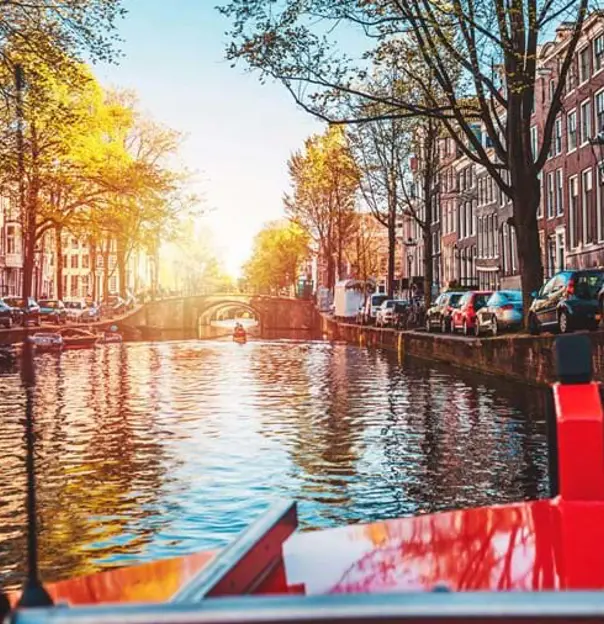 Cruising along Amstel Canal in Amsterdam, Netherlands