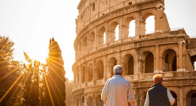 Senior Couple walking towards the Colosseum in Rome