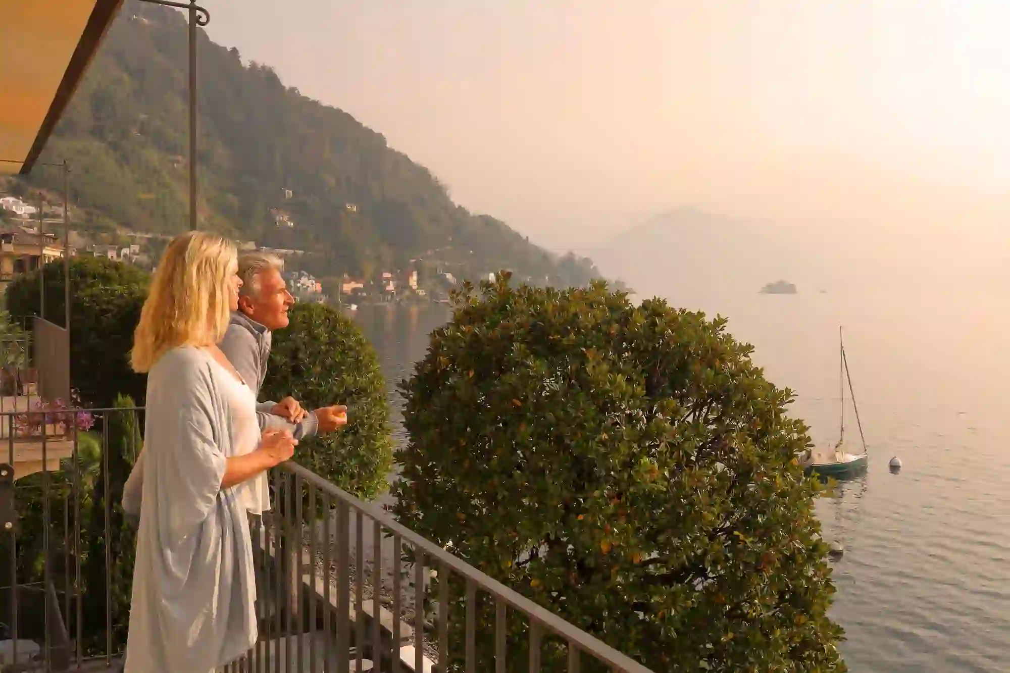 Couple looking out over their balcony to Lake Magiorre