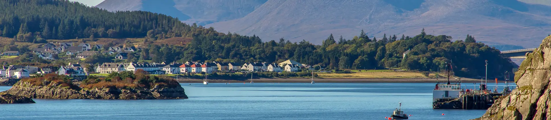View of the Kyle of Lochalsh with Scottish Highland mountains behind it 