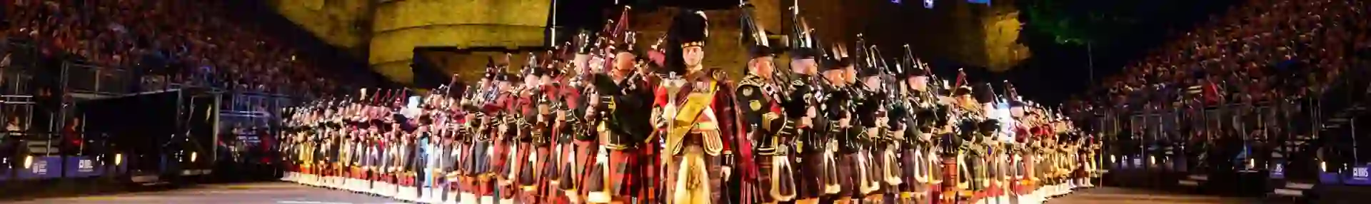 The Royal Edinburgh Military Tattoo lined up in formation infront of Edinburgh castle night time