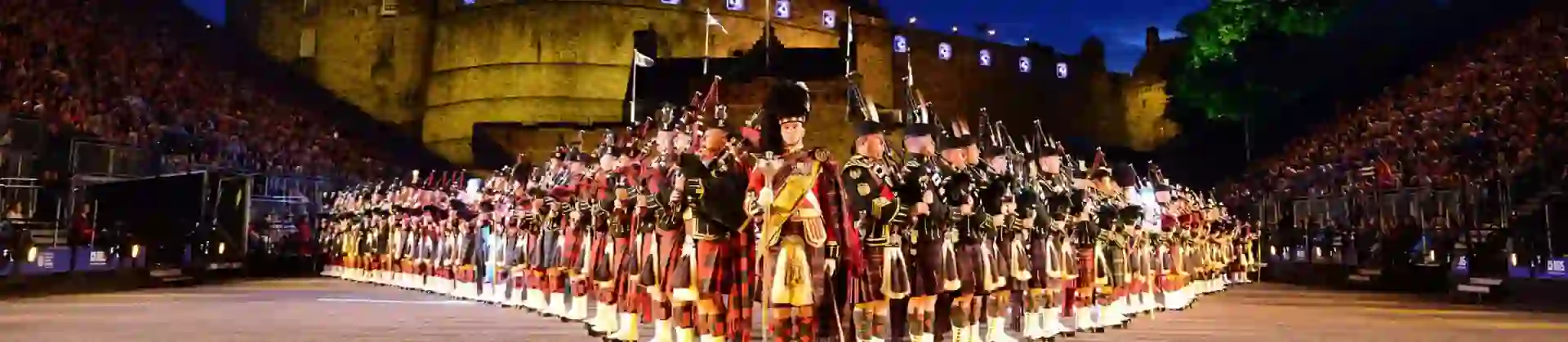 The Royal Edinburgh Military Tattoo lined up in formation infront of Edinburgh castle night time
