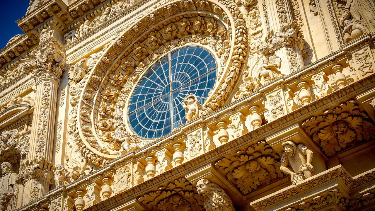 Detailed close-up of the ornate façade of the Basilica of Santa Croce in Lecce