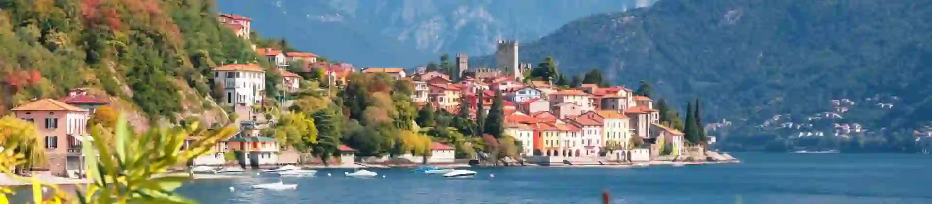 View of houses on the waterfront in Malcesine, Lake Garda with mountains in the distance