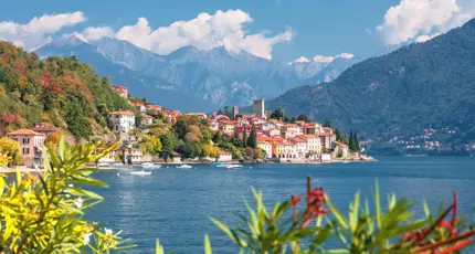 View of houses on the waterfront in Malcesine, Lake Garda with mountains in the distance