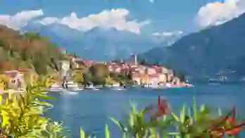 View of houses on the waterfront in Malcesine, Lake Garda with mountains in the distance