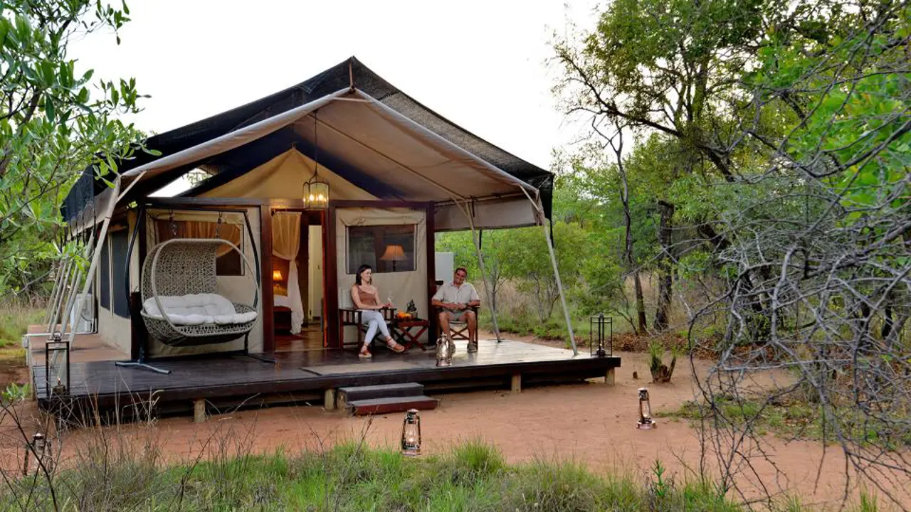 Safari Plains couple sitting outside their tent 