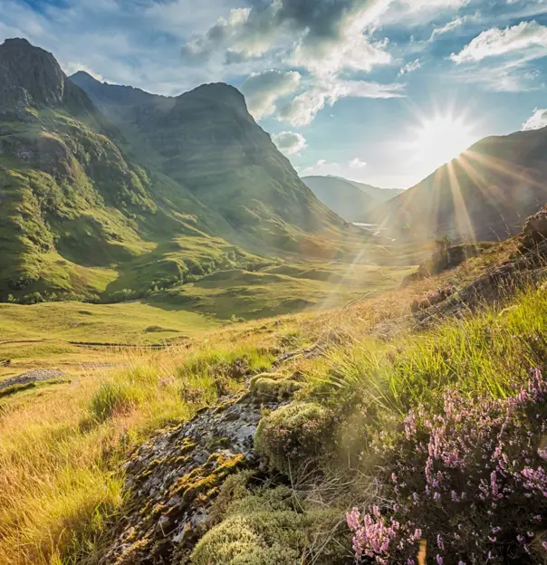 View of the Scottish Highlands with sunshine coming through behind them