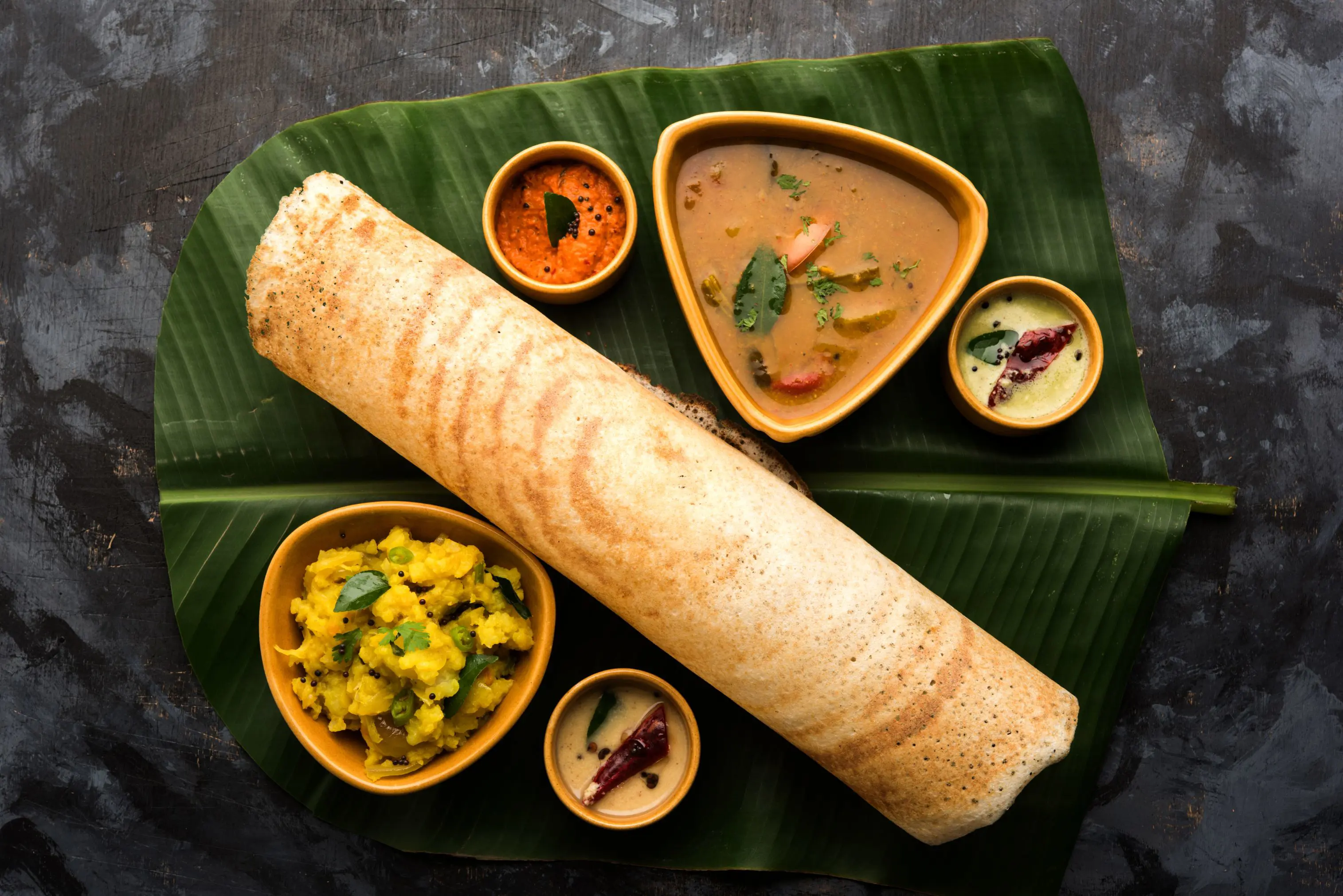 Traditional Indian dosa served with chutneys
