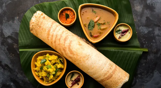 Traditional Indian dosa served with chutneys