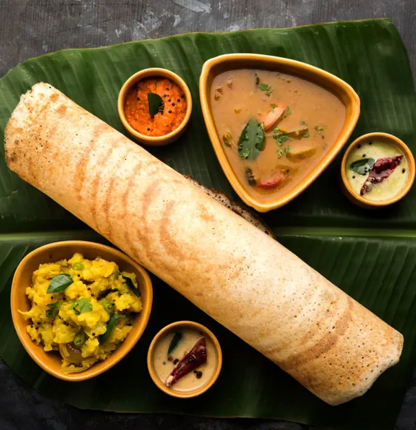 Traditional Indian dosa served with chutneys