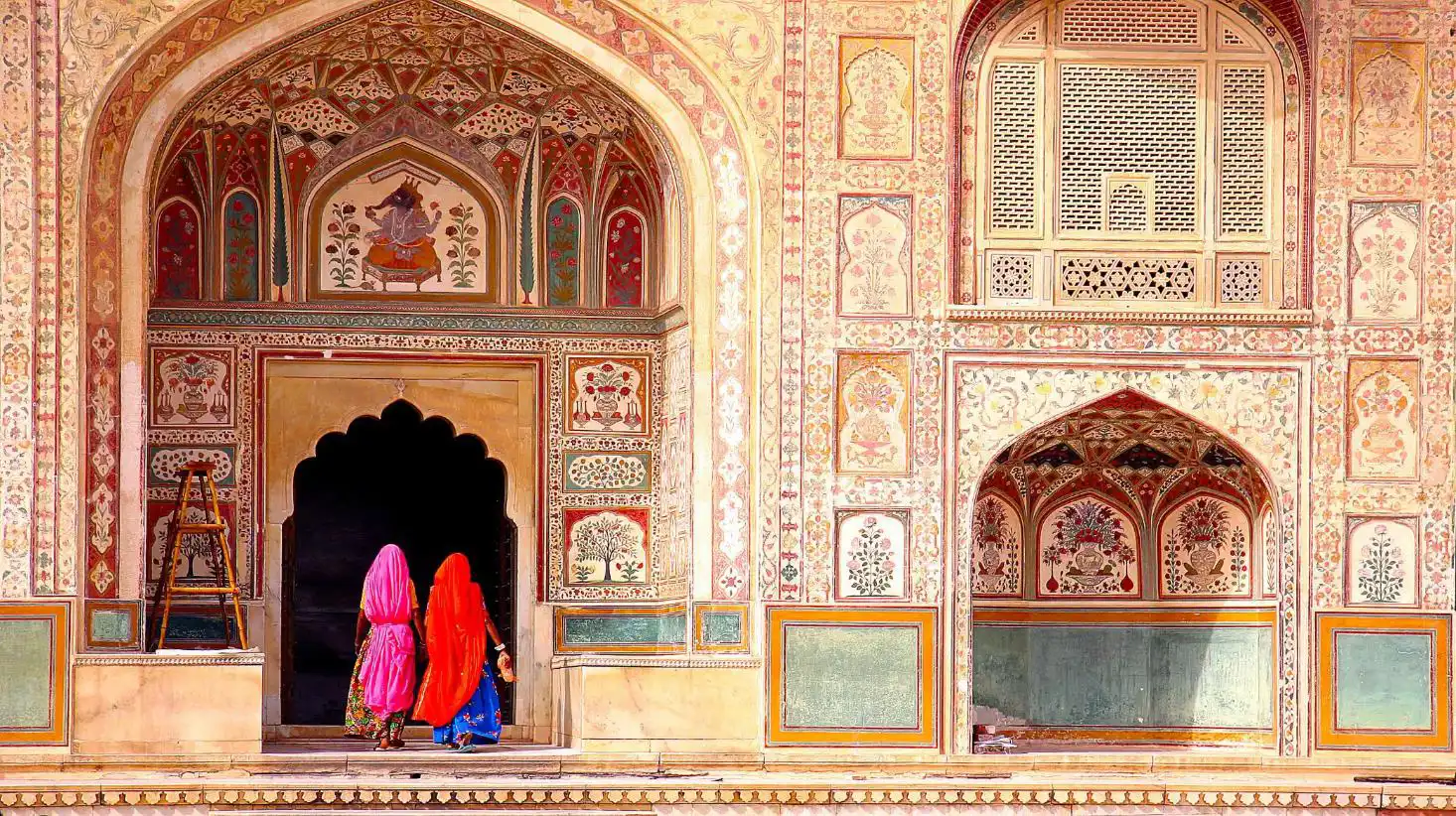 Entrance door of Amber Fort in India, showcasing intricate carvings and traditional Mughal-style sandstone architecture