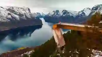 An image man standing on Stegastein Viewing Platform overlooking the fjord