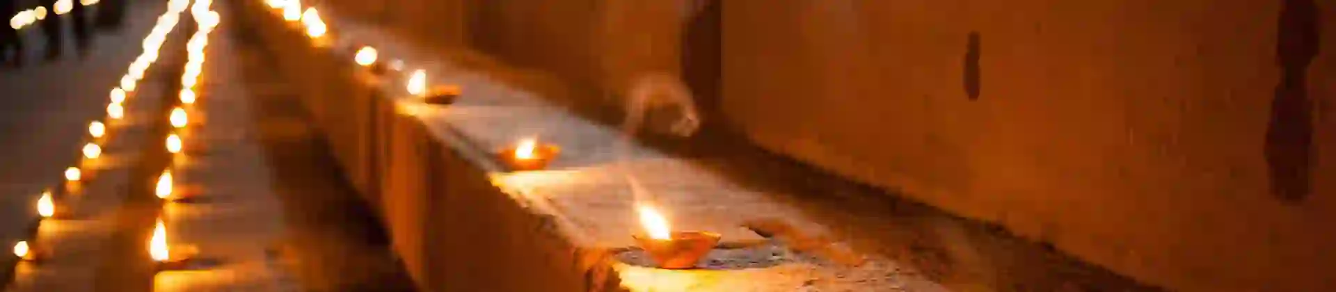 Rows of glowing tealights illuminating stone steps at night during Diwali