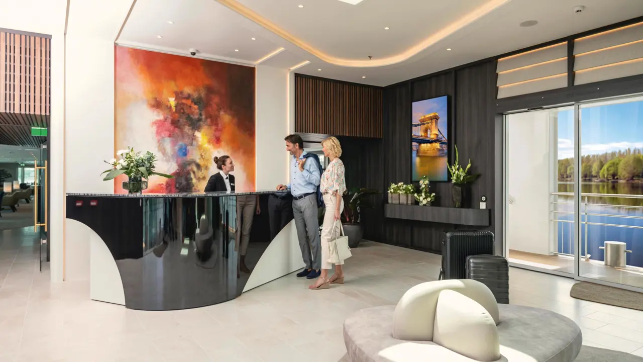 Guest Experience Onboard AMADEUS Cara Reception Couple Checking In At The Reception Crew Member Taking Care Lueftner Cruises Amadeus Moving Pictures