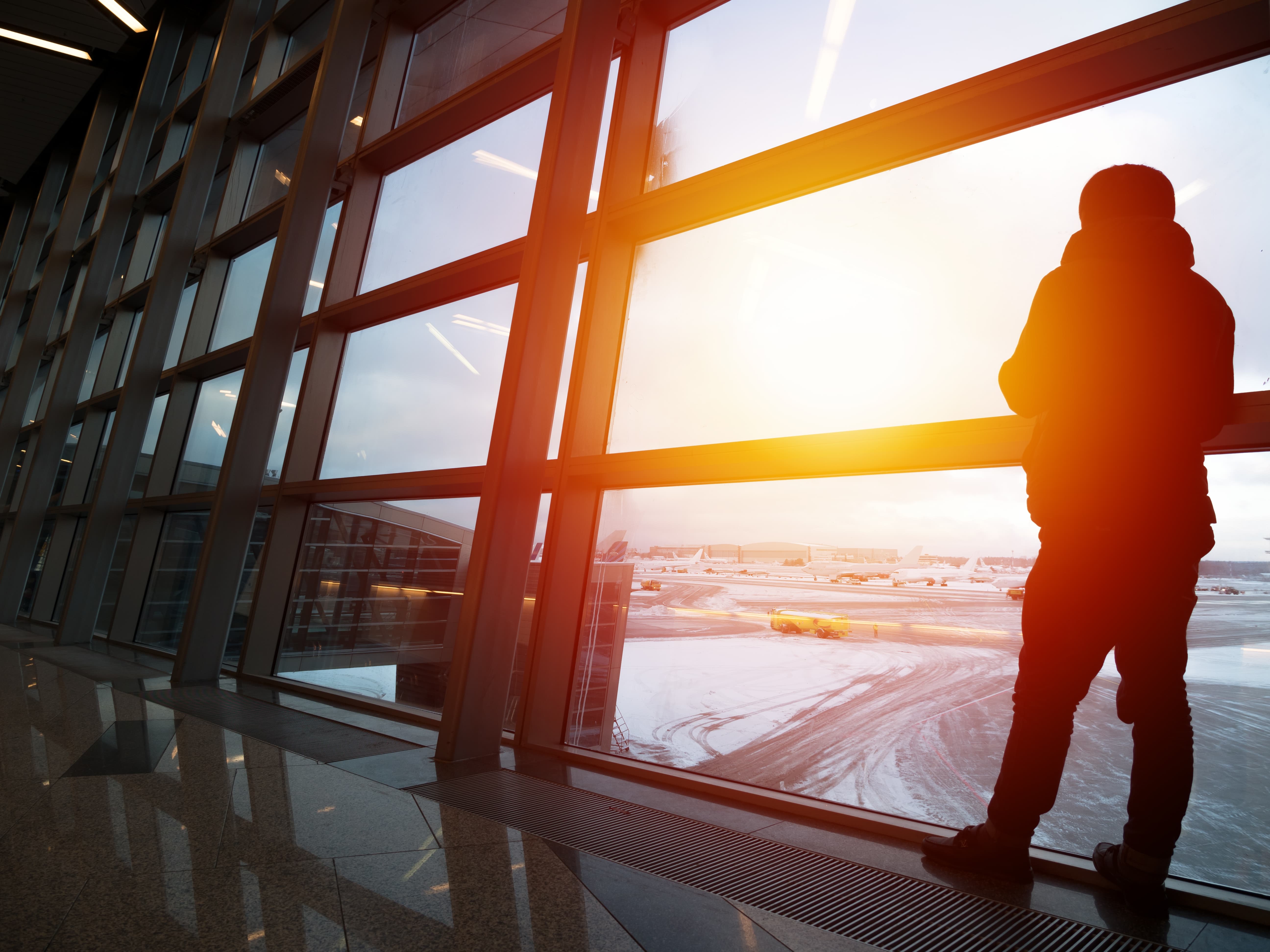 Person looking out the window in an airport