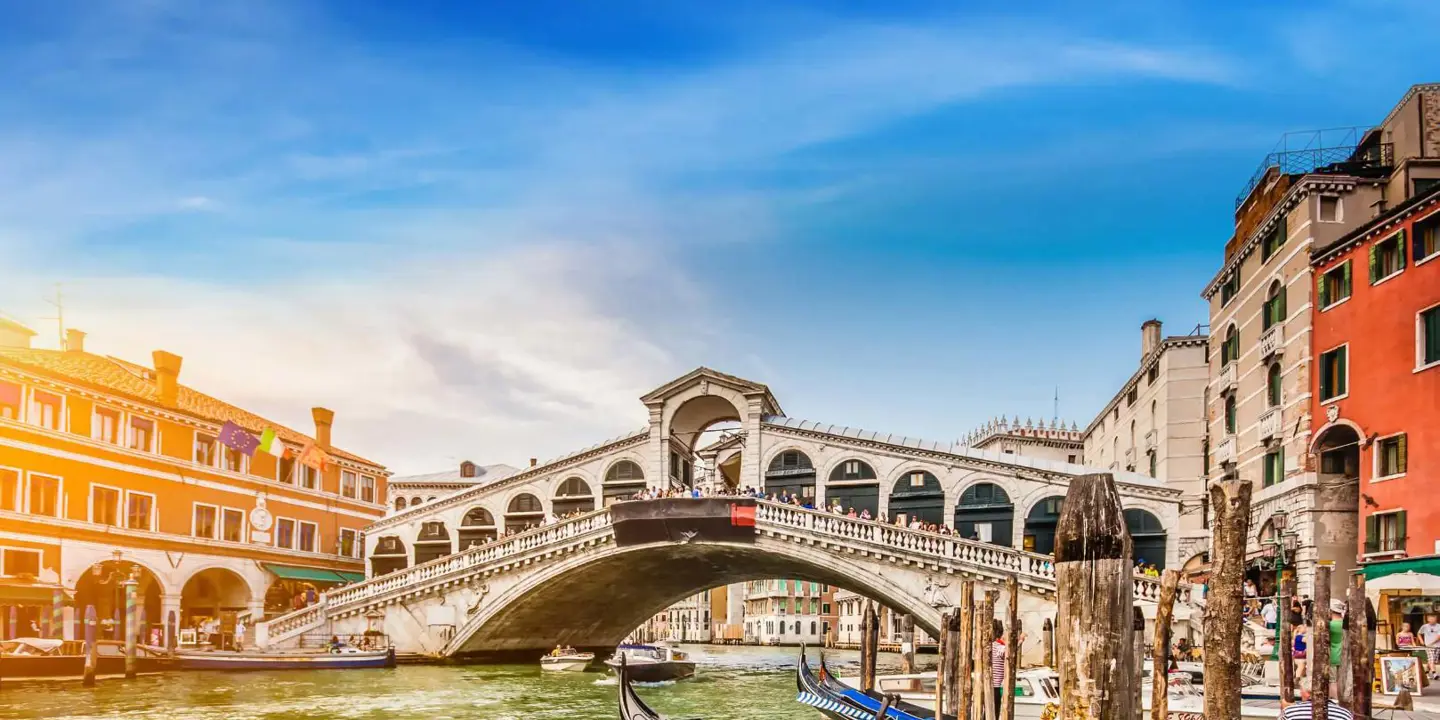 Rialto Bridge, Venice, Italy, with gondola boats in the forefront 