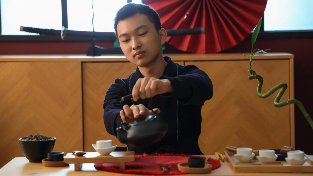 Tea master performing a tea ceremony, China