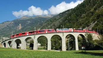 The Bernina Express going across Brusio Spiral Viaduct, Switzerland