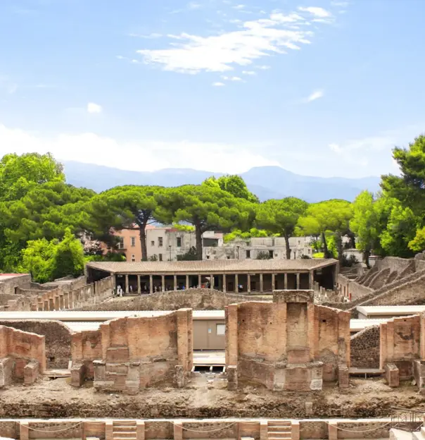 The theatre district in Pompeii with the ancient theatre in the foreground and the Quadriporticus - a large rectangular courtyard surrounded by covered walkways visible behind it