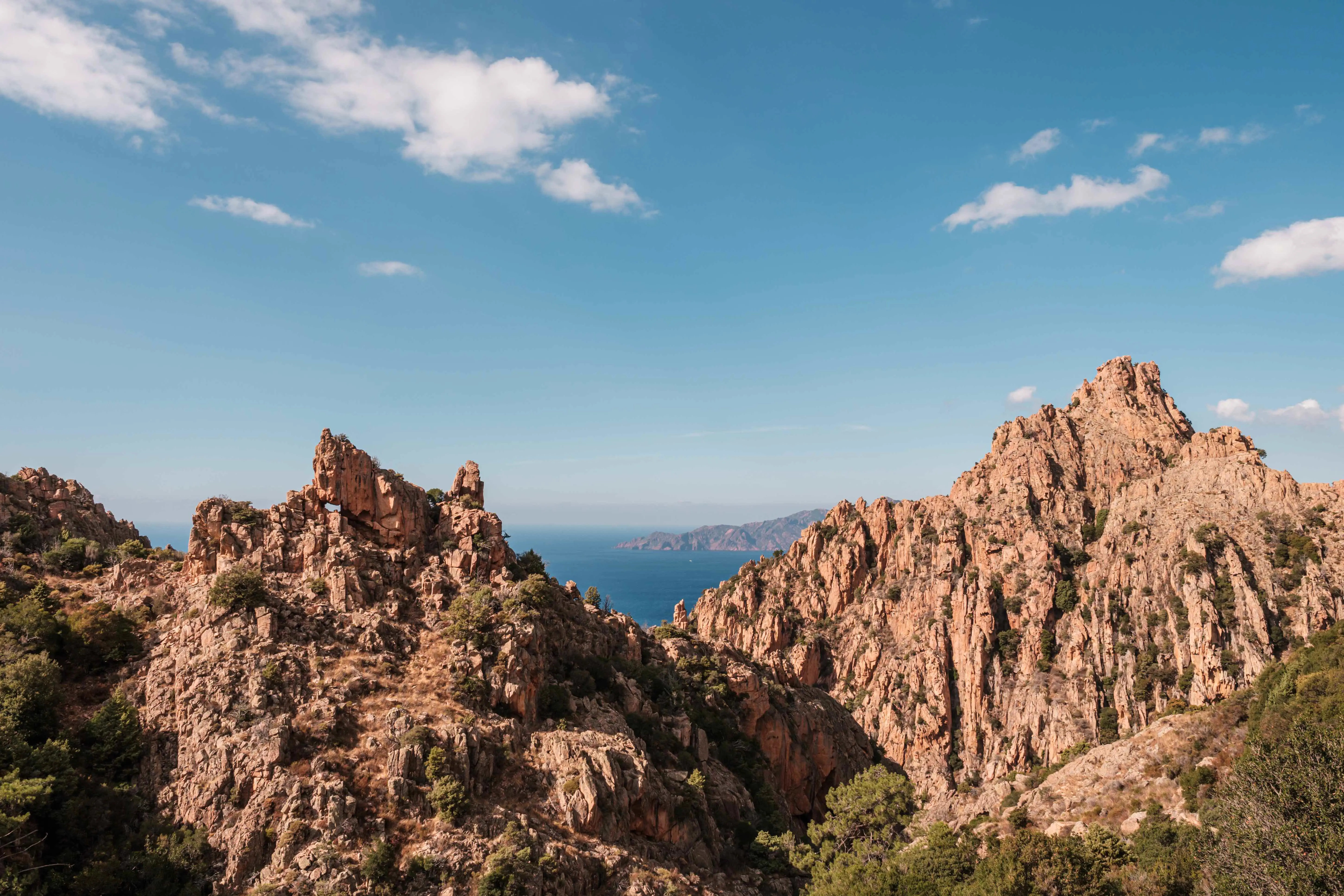 View of rocky mountains, with the sea in the background 