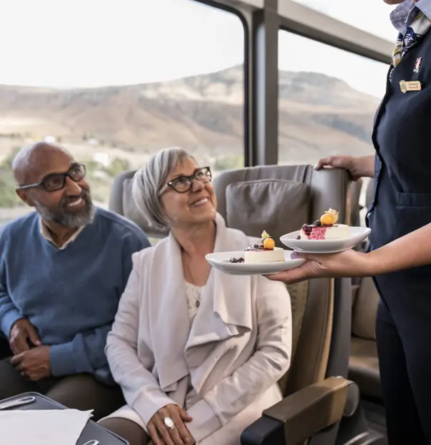 Couple Being Served On Train Through Canadian Rockies