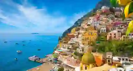 Colourful cliffside village of Positano on the Amalfi Coast, Italy, with pastel-coloured houses cascading down steep hills towards the sparkling blue Mediterranean Sea