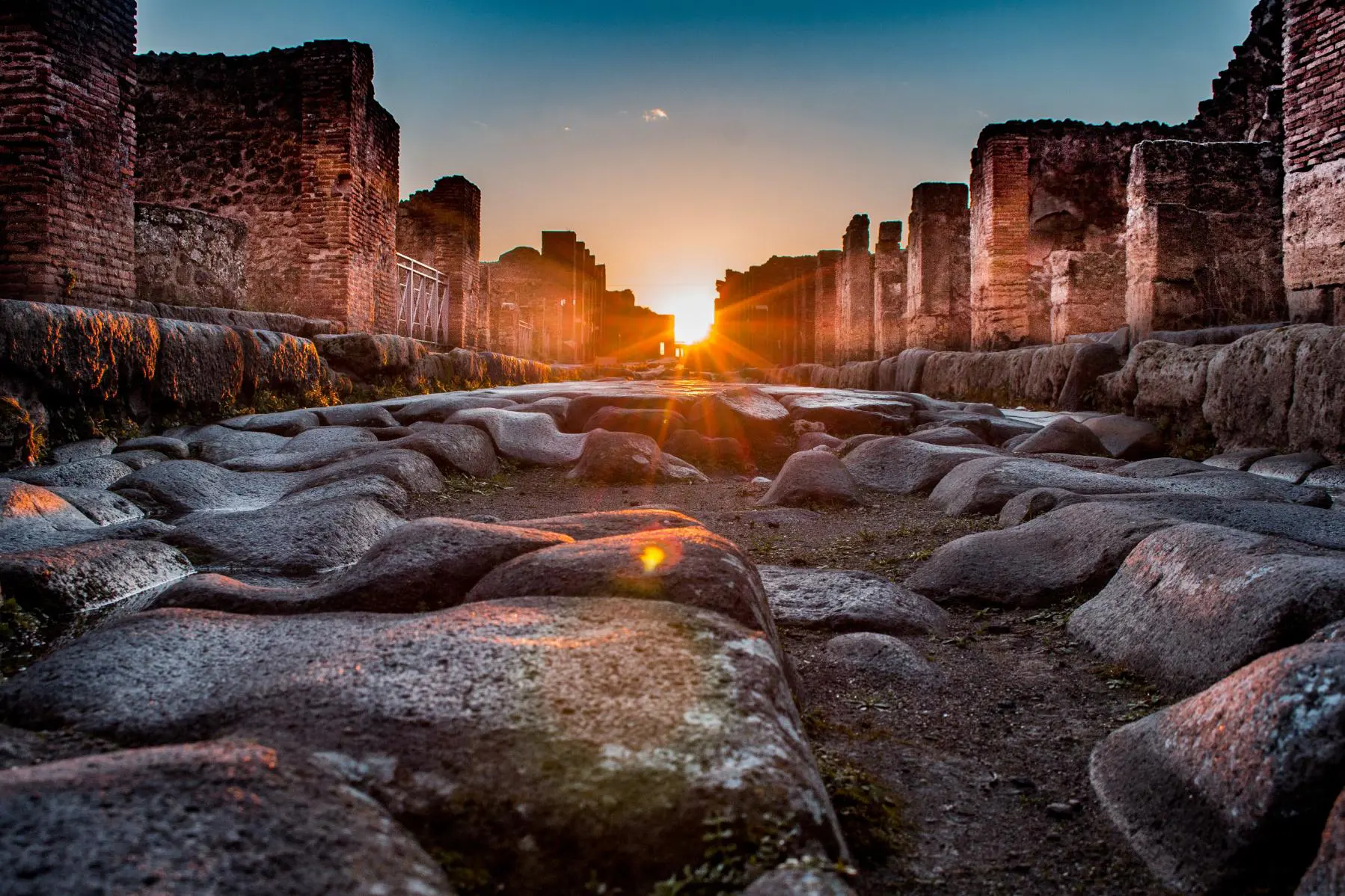 Sunset at Pompeii showing sunbeams shine through the ruins