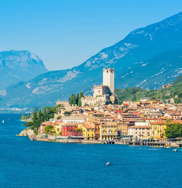 Waterfront in Malcesine, Lake Garda with buildings and mountains in the distance
