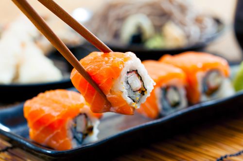 Salmon sushi rolls on a wooden board