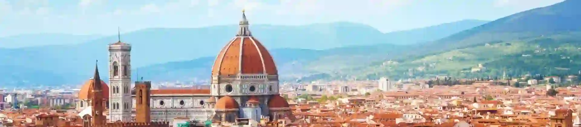 Panoramic view of Florence, Italy, with the Cathedral of Santa Maria del Fiore rising amongst the terracotta rooftops