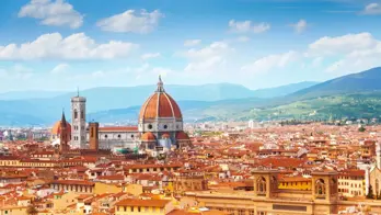 Panoramic view of Florence, Italy, with the Cathedral of Santa Maria del Fiore rising amongst the terracotta rooftops